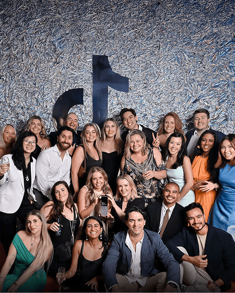 Group shot of M+C Saatchi employees at an event.